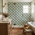 Blue and white patterned ceramic tile in the shower wall, textured with a matte finish.