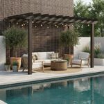 Outdoor seating area with glass tile backsplash, pool, and lush greenery.
