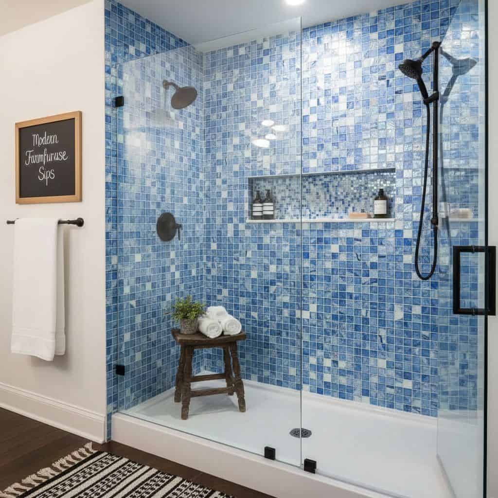 Blue glass tile backsplash in a contemporary bathroom shower.