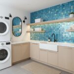 Glass tile backsplash in laundry room with white cabinetry and black fixtures.