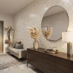 Decorative shell tile wall with a round mirror and modern furniture.