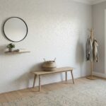 Elegant wall with mother of pearl shell tile, minimal decor, and a wooden coat rack in a modern home interior.