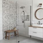 Mother of pearl shell tile used in bathroom shower area for a luxurious, natural look. Features white and iridescent shell ti.
