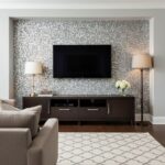 Image of a living room with peel and stick wall tiles behind a TV.