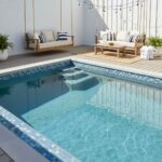 A beautiful outdoor pool featuring blue glass mosaic tiles, creating a sleek and elegant look for backyard swimming areas.
