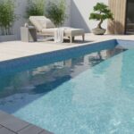 A beautiful swimming pool featuring glass mosaic tiles, perfect for outdoor relaxation and stylish home design.