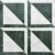 Green marble tile with white accents, textured surface, geometric pattern.