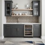 Image of a modern kitchen with peel and stick tile backsplash and dark cabinetry.