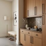 Peel and stick wall tile backsplash in a modern kitchen with wooden cabinets and decorative accents.