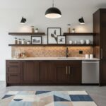 Bright modern kitchen with peel and stick tile backsplash and dark wood cabinets.