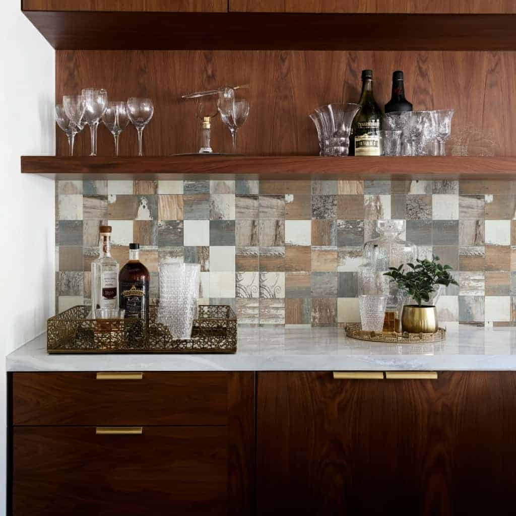 Brightly lit kitchen with peel and stick tile backsplash and wooden shelves.