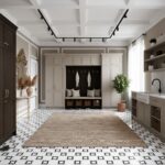 Bright, neutral-toned interior featuring a white built-in with black hooks and accents, complemented by a beige rug and black.