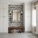 Mirror with Wall Sconces and Storage Cabinets.