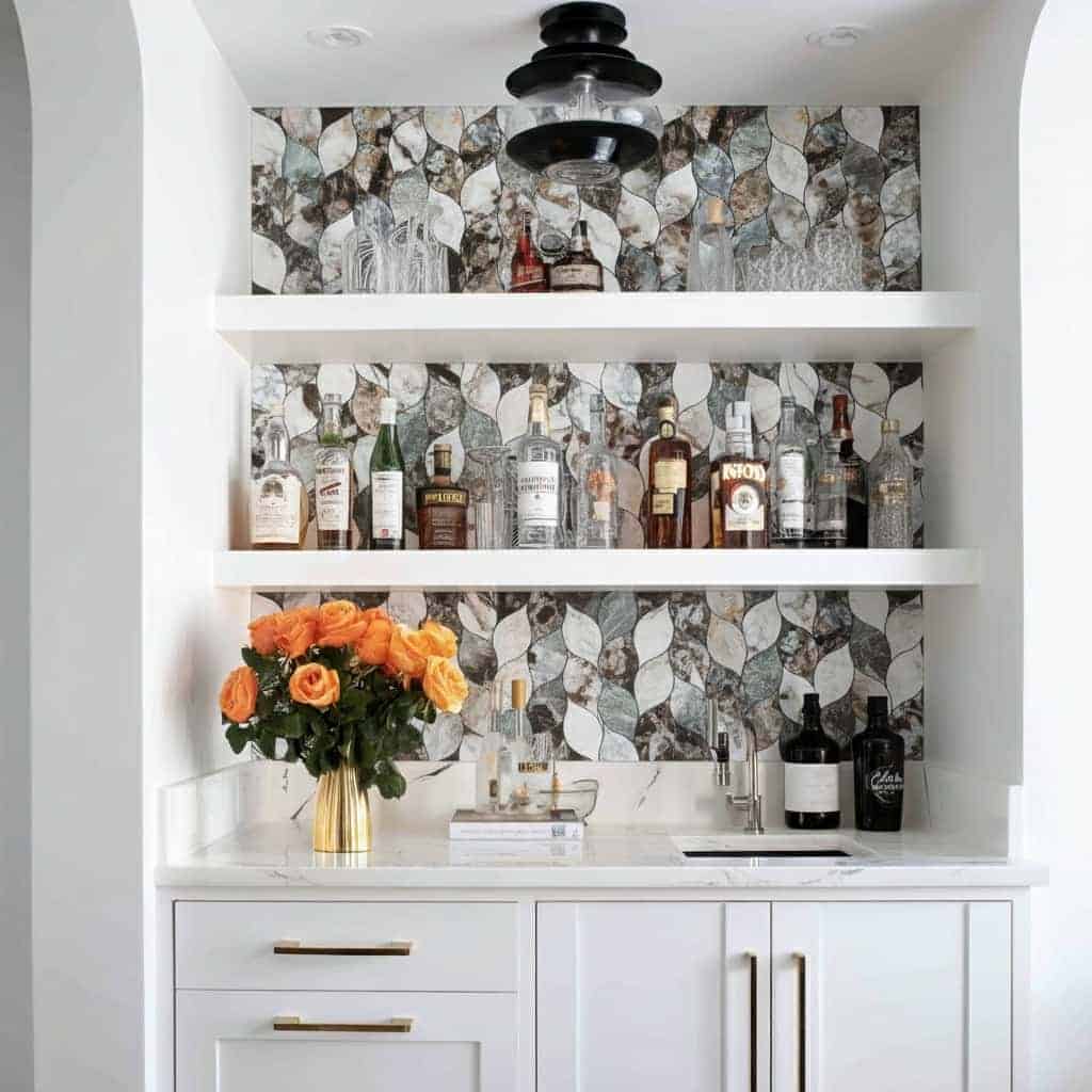 Modern bar area with peel and stick tile backsplash, white cabinetry, and decorative bottles.