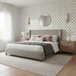 Bright bedroom featuring beige and white tones with textured wallpaper, soft bedding, and wooden furniture.