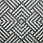 Black and white striped ceramic tile with a textured surface and a modern geometric design.