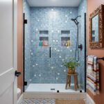 Modern glass tile shower with built-in niches and black fixtures in a stylish bathroom.