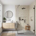Glass tile backsplash in modern bathroom shower.