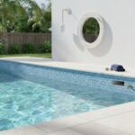 Poolside glass mosaic tile backsplash for a modern outdoor pool area.