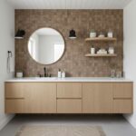 A modern bathroom with peel and stick wall tiles, a round mirror, and minimalist decor for a sleek, easy-to-install upgrade.