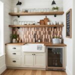 Image of a kitchen with peel and stick tile backsplash, wooden shelves, and white cabinetry.