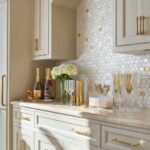 Elegant kitchen with mother of pearl shell tile backsplash and gold accents.