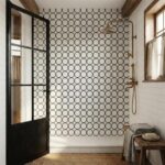 Black circular tiles with matte finish in shower wall.