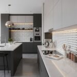 Bright kitchen with gray and white mosaic tiles, smooth countertops, and sleek cabinetry.