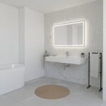 Bright white bathroom with textured wall tiles, illuminated mirror, and minimalist fixtures. Features a freestanding bathtub.