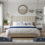 Nautical-themed bedroom with polka dot wallpaper, beige upholstered headboard, and white furniture. Decor includes framed pic.