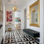 Black and white geometric patterned tile with a glossy finish and sharp contrast.