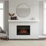 Fireplace with mother of pearl shell tile accent wall and round mirror above.