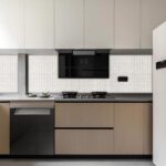 A modern kitchen featuring a sleek shell tile backsplash made from mother of pearl and oyster shells, adding elegance and tex.