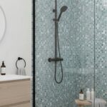 Blue mosaic tile with textured surface and small square pattern, creating a vibrant and stylish look.