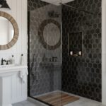 Black hexagon matte tile with gold grout, textured surface, in a modern bathroom.