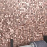 Pink and beige hexagon tiles with matte finish, textured surface, arranged in a honeycomb pattern.