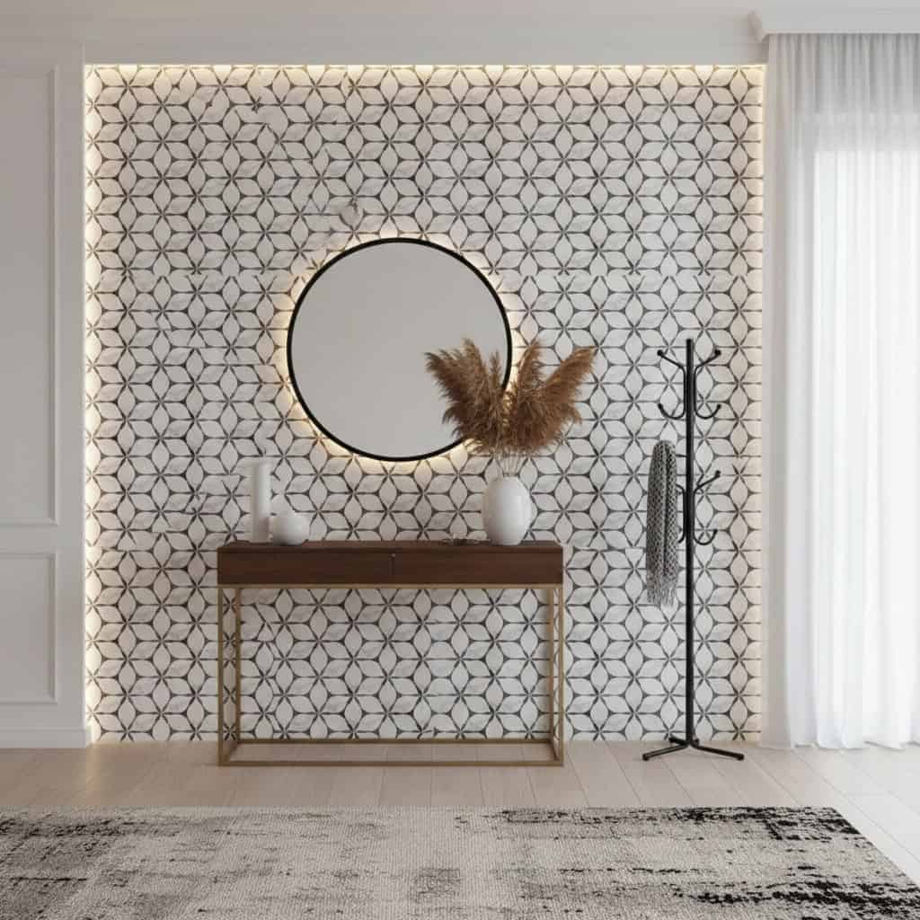 Geometric patterned tile wall in neutral tones with textured surface and round mirror, wooden console, and decorative vases i.