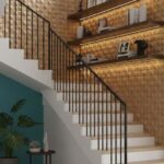 Gold textured ceramic tile with geometric pattern, smooth finish, and reflective surface.