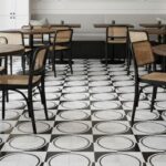 Black and white patterned ceramic tiles with a glossy finish, featuring circular and square designs.