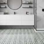 White and gray marble tiles, textured patterned floor, sleek minimalist design.