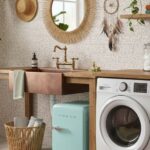 Beige speckled tile with smooth texture, in a cozy kitchen setting with wooden countertops and white washing machine and drye.
