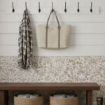 Neutral pebble-textured tile wall with hooks and accessories.