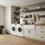 Bright, modern laundry space with white cabinets, textured tile wall, and black fixtures.