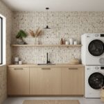 Light beige speckled tile wall with textured surface in a modern laundry room.