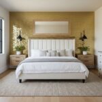Bright white bed with striped pillows, flanked by matching wooden nightstands with potted plants, against a gold hexagon tile.