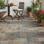 Earth-tone ceramic tile with a textured surface, suitable for outdoor patios and garden spaces.