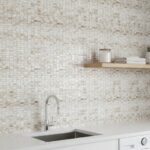Beige mosaic tile wall with textured, small square tiles, perfect for contemporary home decor and accent walls.