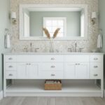 Bright white bathroom vanity with a large mirror and two wall-mounted lights.