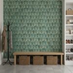 Teal wallpaper with gold geometric pattern, textured finish, in a stylish entryway.