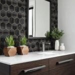 Black and gold geometric patterned tile with a glossy finish.